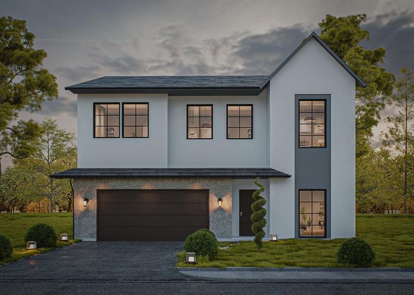 View of front facade featuring a yard and a garage