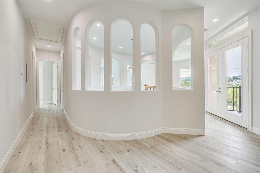 Hallway leading to bedrooms at the top of the stairs.  Lots of natural light and beautiful architecture.