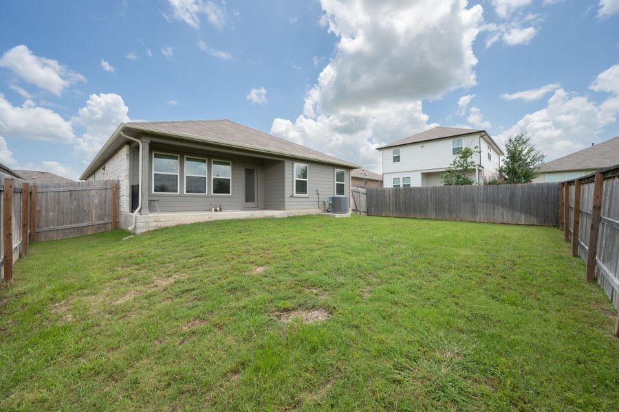Front exterior of a new home in Carillon, Manor, TX, highlighting curb appeal (Image 21). Front exterior of a new home in Carillon, Manor, TX, highlighting curb appeal (Image 21).