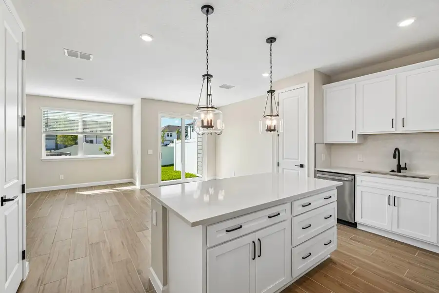 As you walk down the foyer you are welcomed into an open kitchen, dining and family room space