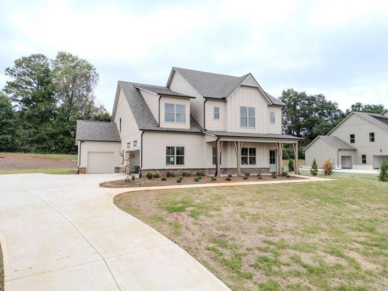 Front exterior of a new home in , Hoschton, GA, highlighting curb appeal (Image 27).