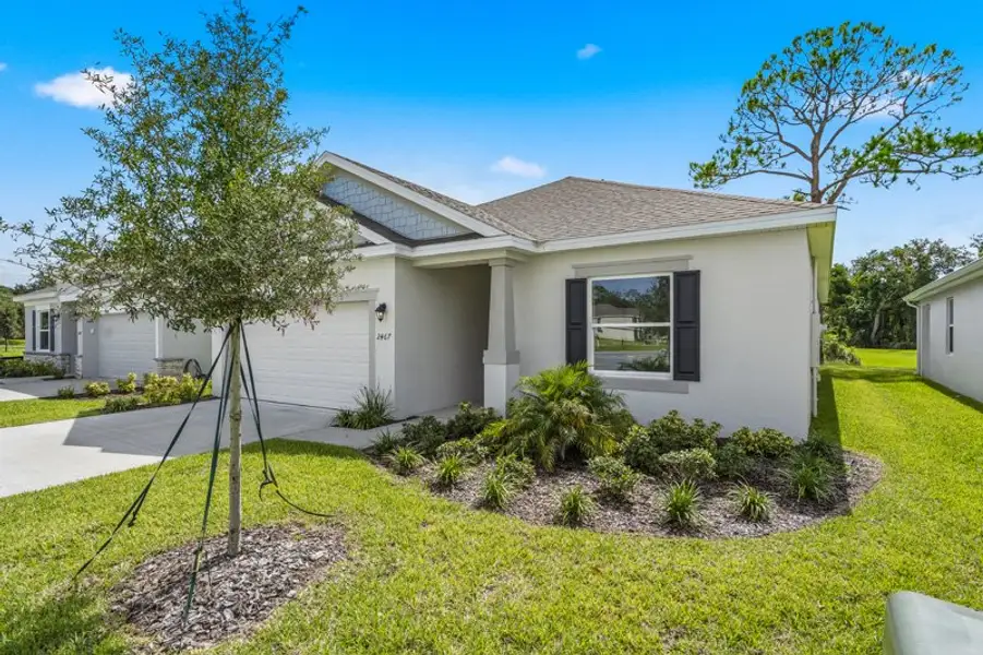 Front exterior of a new home in Huntington Park, Titusville, FL, highlighting curb appeal (Image 21). Front exterior of a new home in Huntington Park, Titusville, FL, highlighting curb appeal (Image 21).