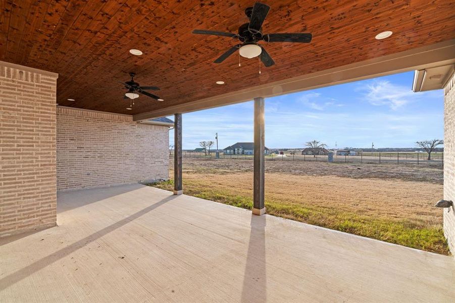 View of patio featuring a rural view and ceiling fan