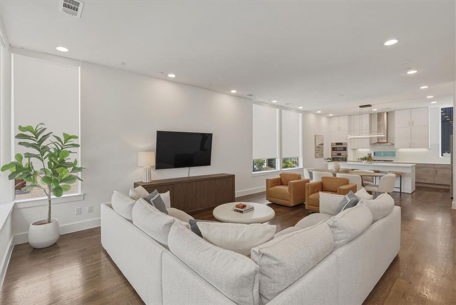 Living area featuring recessed lighting and dark wood-style floors