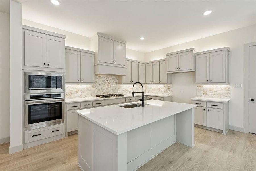 The spacious kitchen island creates the perfect place for friends and family to gather round.