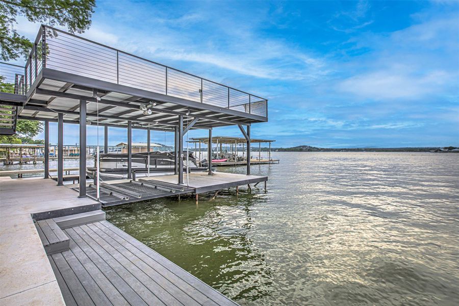 View of dock with a water view and boat lift