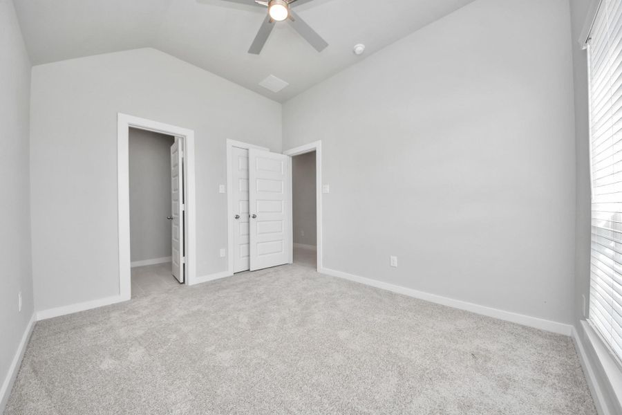 Generously sized secondary bedrooms featuring spacious closets, soft and inviting carpeting underfoot, large windows allowing plenty of natural light, and the added touch of privacy blinds for your personal retreat. Sample photo of completed home with similar floor plan. Actual colors and selections may vary.