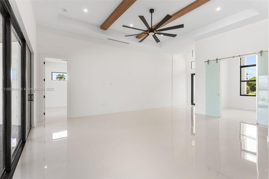 Exposed WOOD BEAMS and COVE CEILING add ARCHITECTURAL INTEREST and WARMTH, creating an ATMOSPHERE IDEAL FOR RELAXATION or HOSTING!