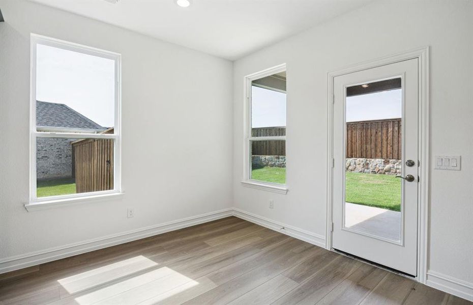 Dining nook off kitchen with large windows
