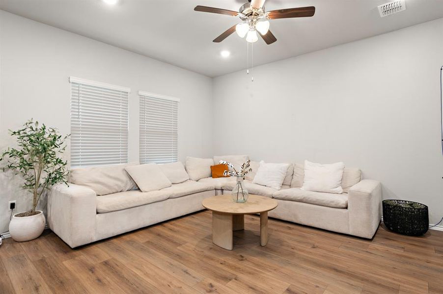 Living area featuring light wood-type flooring, recessed lighting, and ceiling fan Living area featuring light wood-type flooring, recessed lighting, and ceiling fan