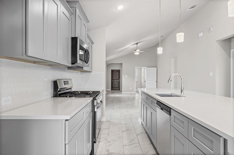 Sleek modern cabinetry and polished stone countertops define this airy, open culinary space. Sleek modern cabinetry and polished stone countertops define this airy, open culinary space.