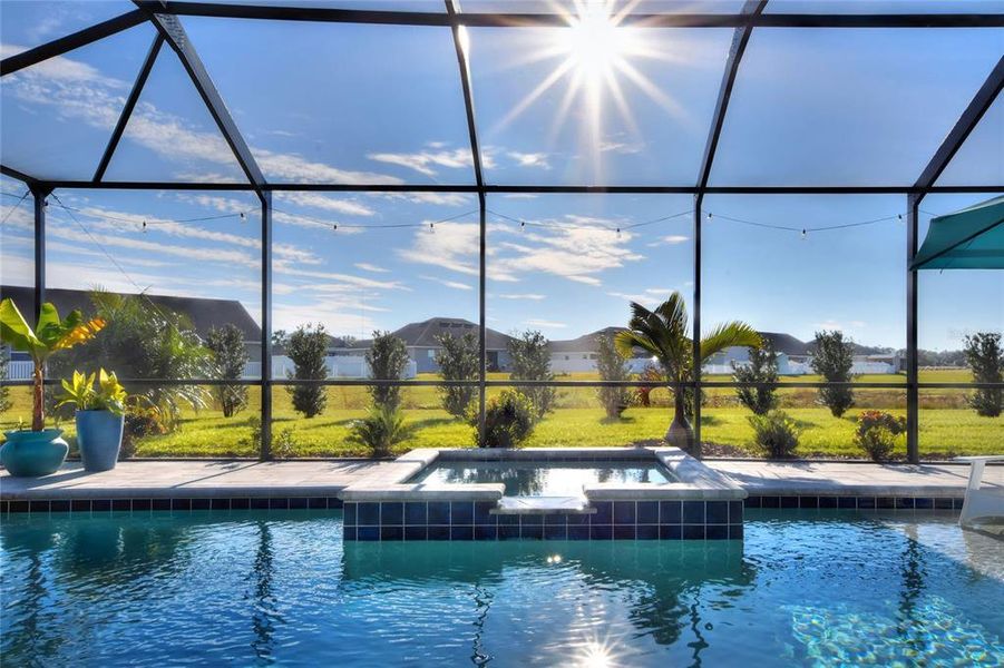 Pool overlooking landscaped backyard.