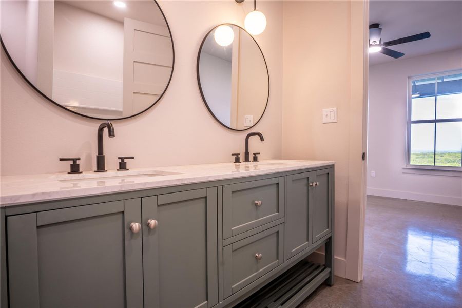 Full bathroom featuring double vanity, concrete floors, and ceiling fan