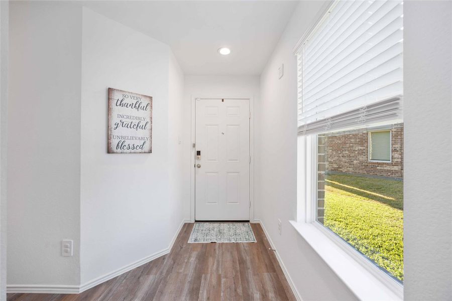 Entry FoyerBright and welcoming entry featuring neutral finishes, recessed lighting, and durable wood-look LVP flooring. A large window fills the space with natural light, creating an inviting first impression and a smooth transition into the main living areas of the home. Entry FoyerBright and welcoming entry featuring neutral finishes, recessed lighting, and durable wood-look LVP flooring. A large window fills the space with natural light, creating an inviting first impression and a smooth transition into the main living areas of the home.