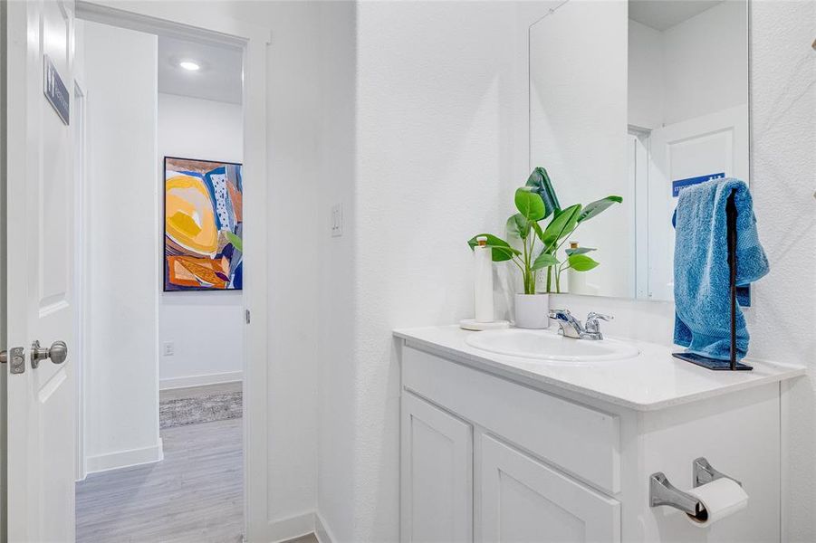 Bathroom featuring vanity and wood-type flooring