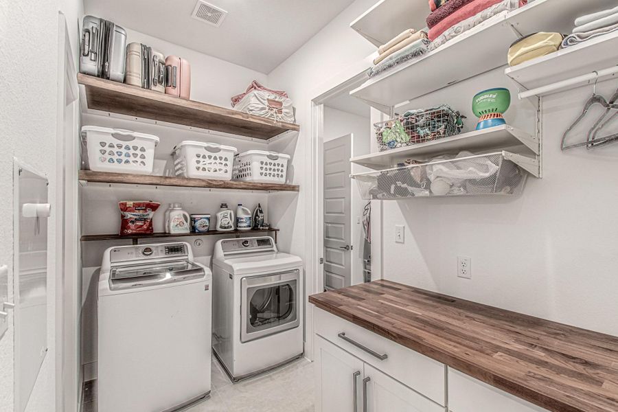 This incredible utility room is conveniently connected to the primary closet to make laundry day a breeze.