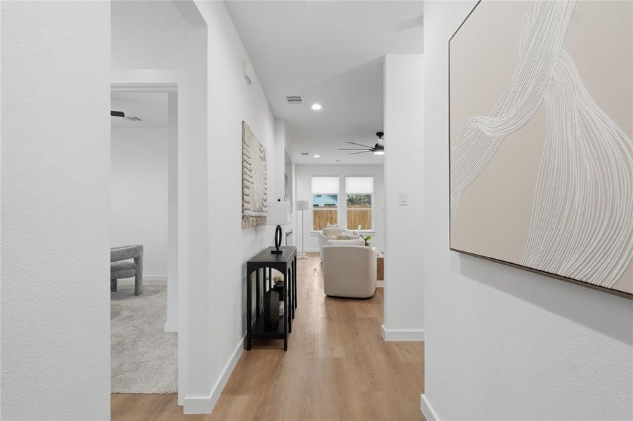 Hallway with light wood-type flooring and recessed lighting Hallway with light wood-type flooring and recessed lighting