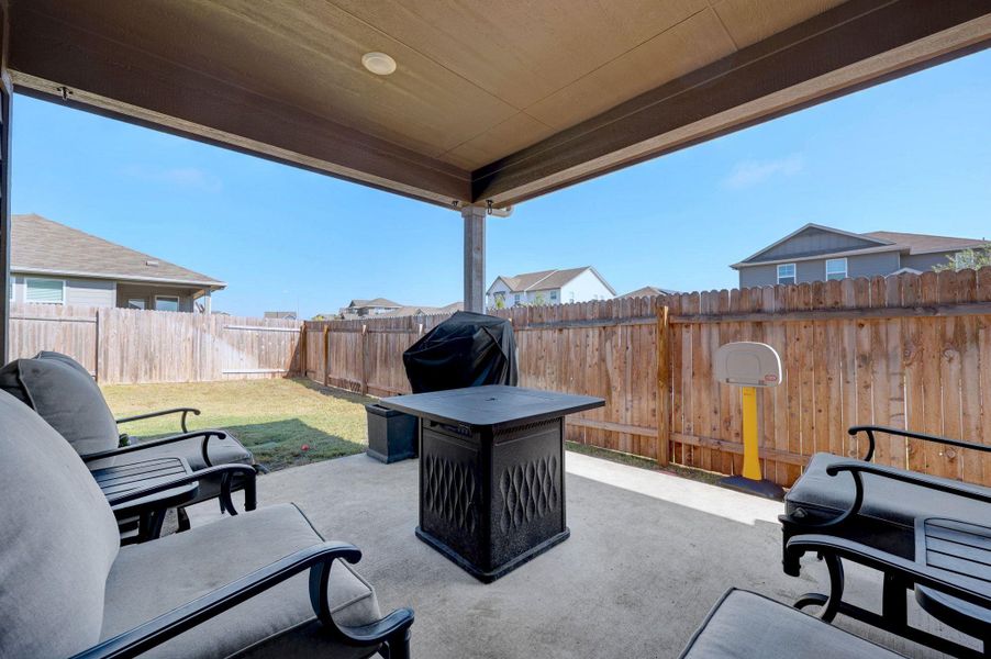 Fenced backyard with a patio and a grill Fenced backyard with a patio and a grill