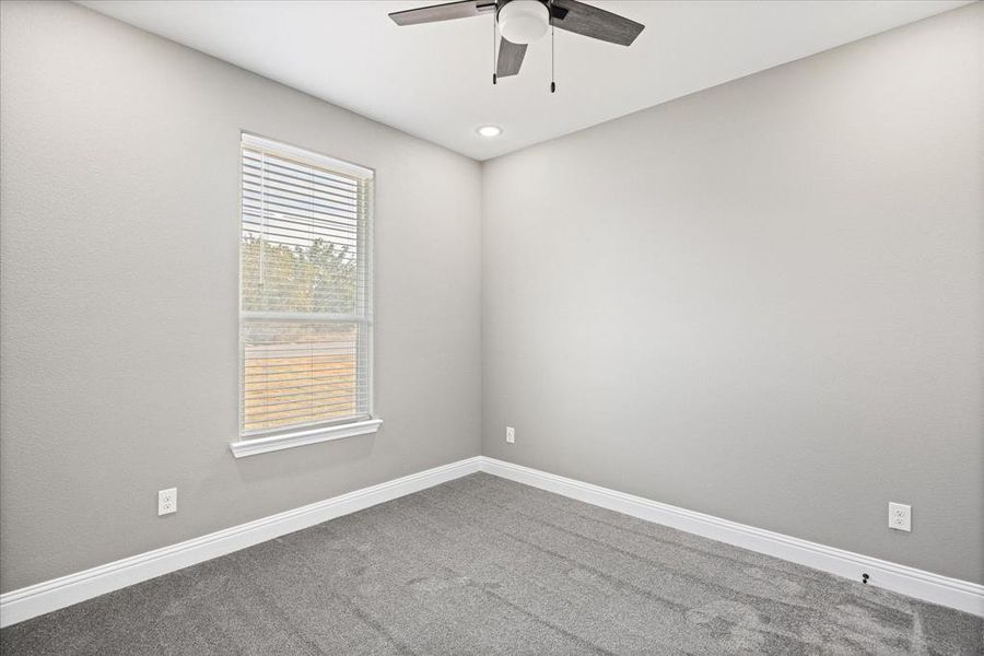 Carpeted BR with ceiling fan