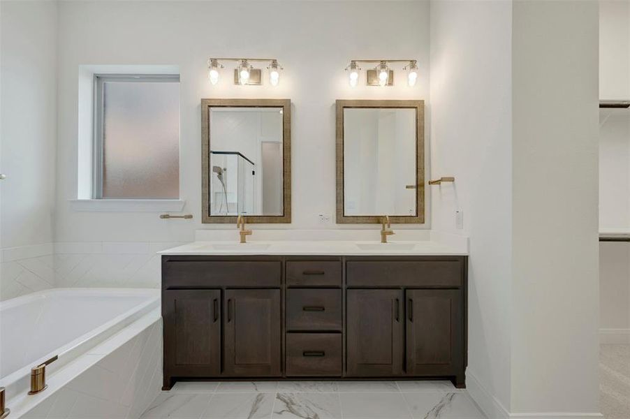 Dual vanity with dark wood-finish cabinetry and white countertops