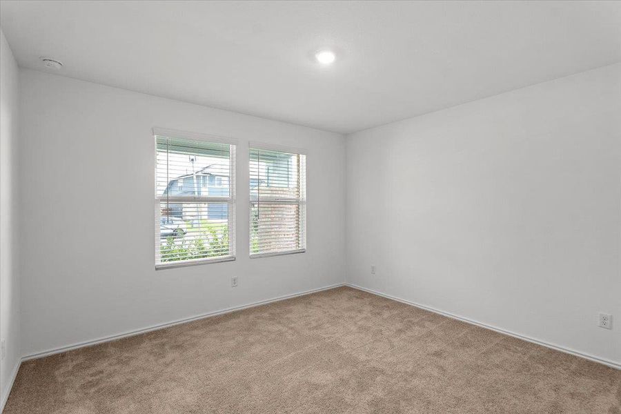 A well-lit, neutral-toned room features clean walls and soft carpeting. A well-lit, neutral-toned room features clean walls and soft carpeting.