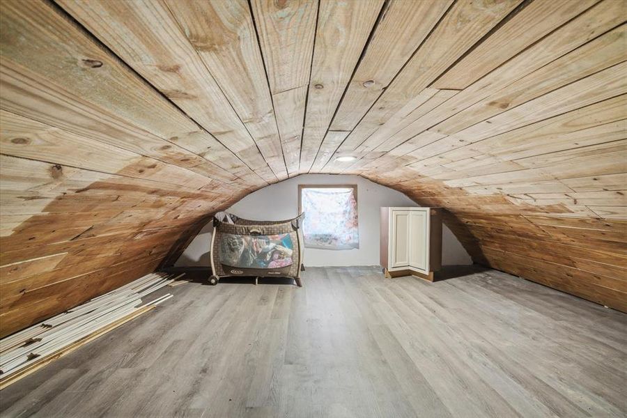 Bonus room featuring light wood-type flooring and wooden ceiling
