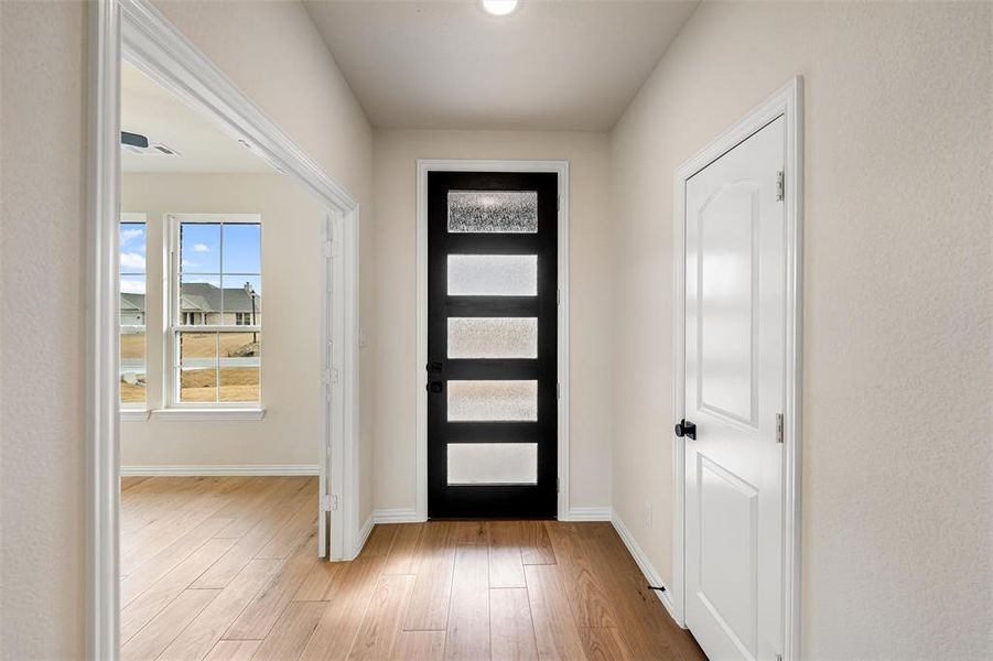 Entrance foyer featuring light wood-type flooring and baseboards
