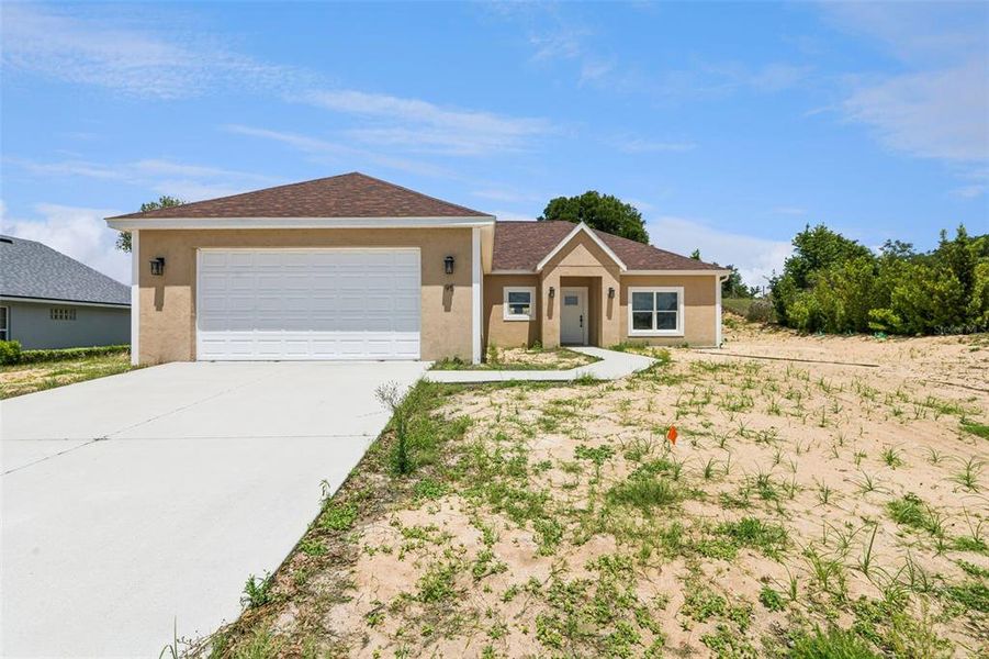 Front exterior of a new home in , Umatilla, FL, highlighting curb appeal (Image 4).