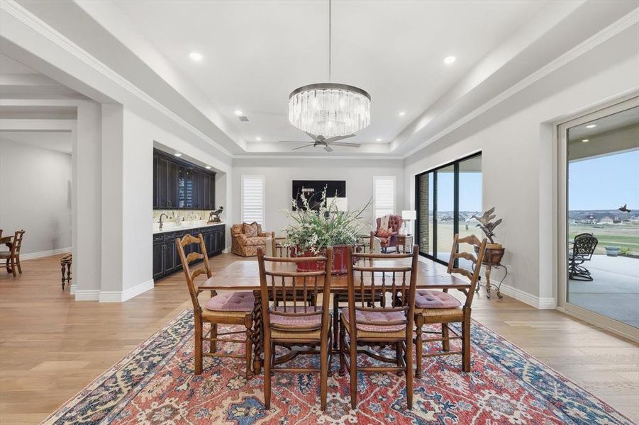 Perfectly situated between the Great Room and Gourmet Cook’s Kitchen, this Refined Dining Space features its own Double Sliding Glass Doors and Effortless Access to the Outdoor Pavilion Designed for Seamless Entertaining and offers an Elegant Setting for both Intimate Dinners and Grand Gatherings.