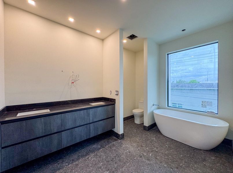 (as of April 8, 2026) the primary bath includes a double vanity, an oversized shower, and freestanding tub, both controlled with Kohler's Anthem Digital Controls