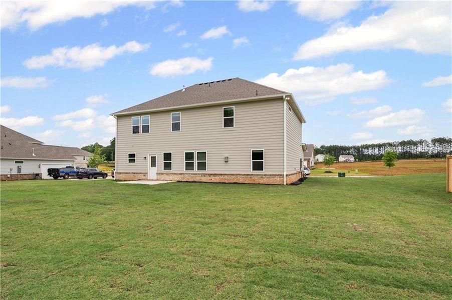 Front exterior of a new home in Anderson Point Estates, McDonough, GA, highlighting curb appeal (Image 1).