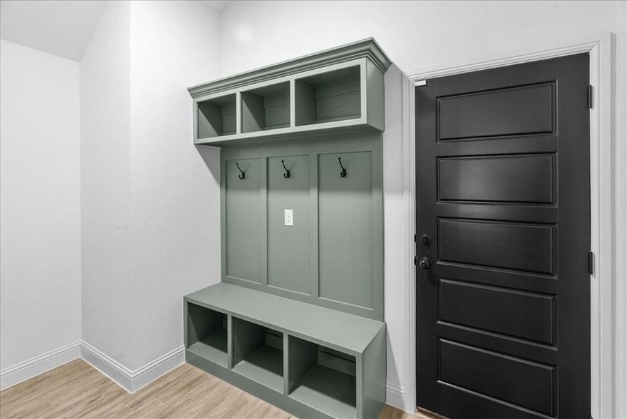 Mudroom featuring baseboards and light wood-type flooring