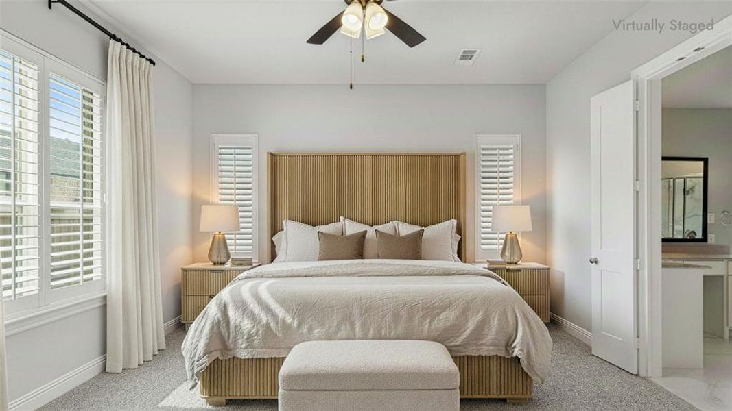 Carpeted bedroom with ceiling fan and baseboards Carpeted bedroom with ceiling fan and baseboards