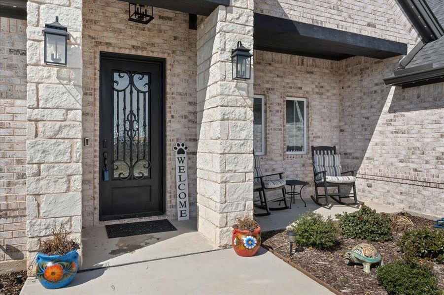 Doorway to property with stone siding and brick siding