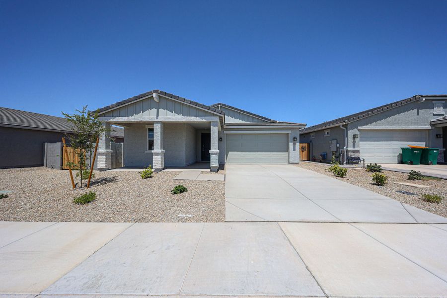 Front exterior of a new home in The Lakes at Rancho El Dorado, Maricopa, AZ, highlighting curb appeal (Image 1). Front exterior of a new home in The Lakes at Rancho El Dorado, Maricopa, AZ, highlighting curb appeal (Image 1).