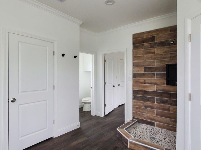 double walk in closet with separated toilet and shower.