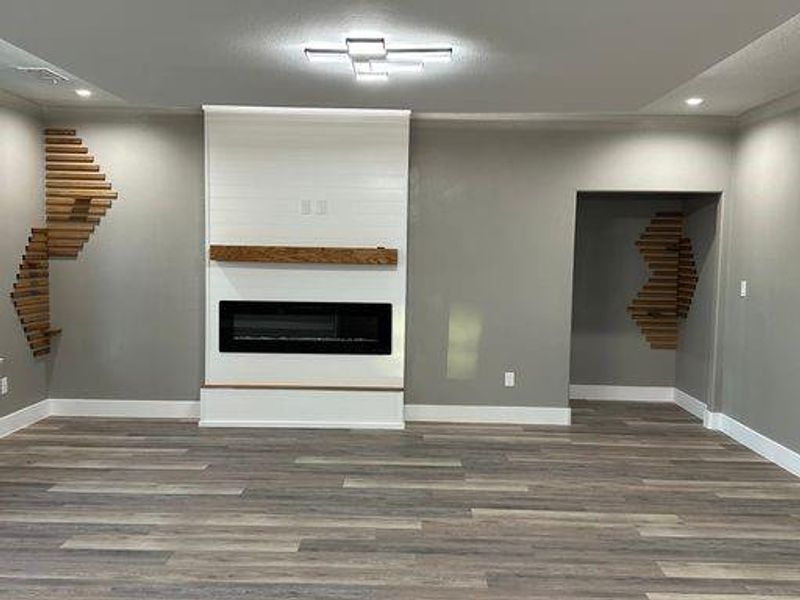 Unfurnished living room with dark wood-type flooring