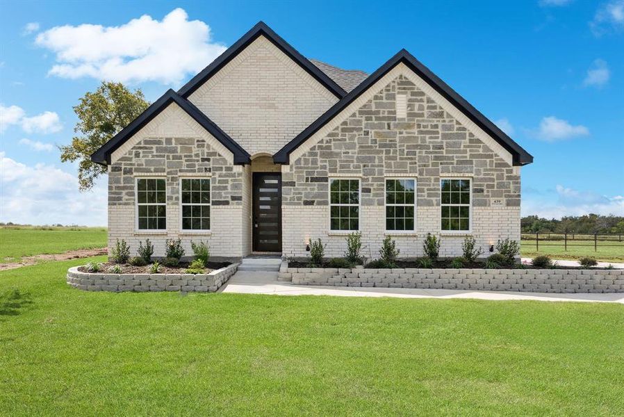 View of front of property with brick siding and a front yard View of front of property with brick siding and a front yard