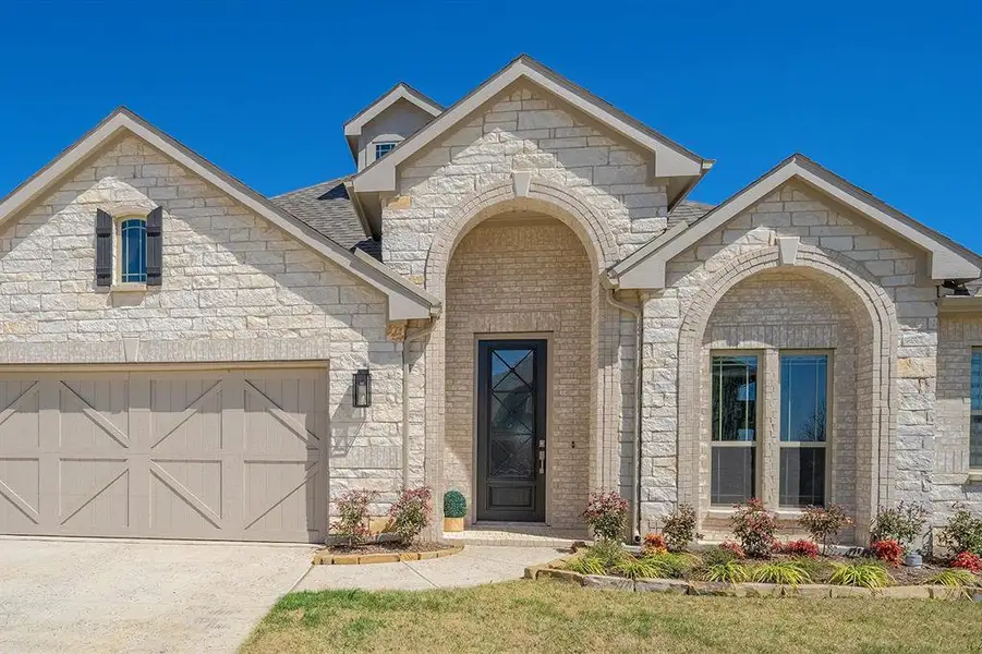 Front exterior of a new home in , Prosper, TX, highlighting curb appeal (Image 1). Front exterior of a new home in , Prosper, TX, highlighting curb appeal (Image 1).