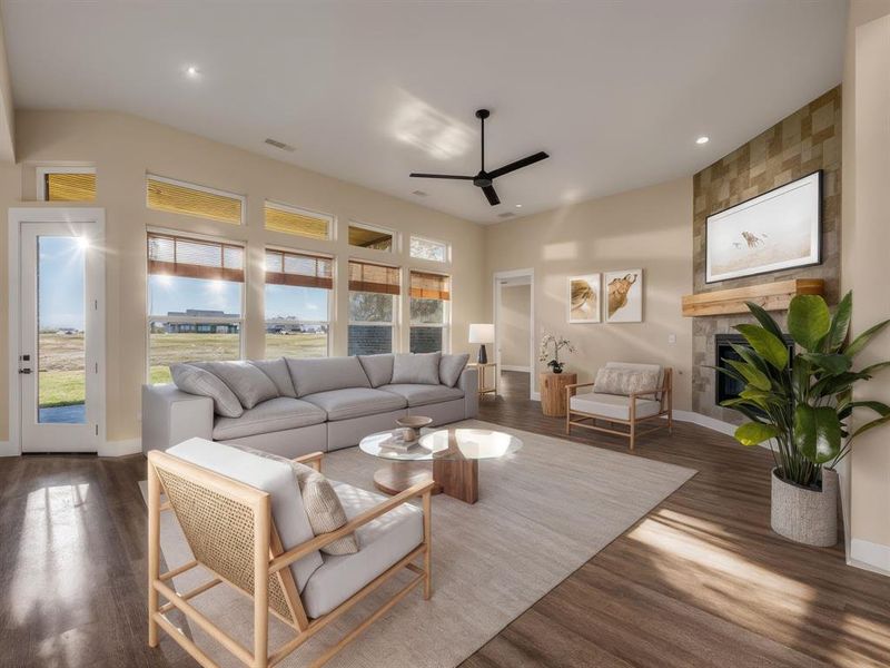 Staged Living area with a tile fireplace, ceiling fan, wood finished floors, and recessed lighting Staged Living area with a tile fireplace, ceiling fan, wood finished floors, and recessed lighting