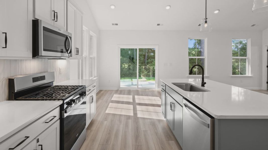 Kitchen with seamless dining space and views to the rear covered porch