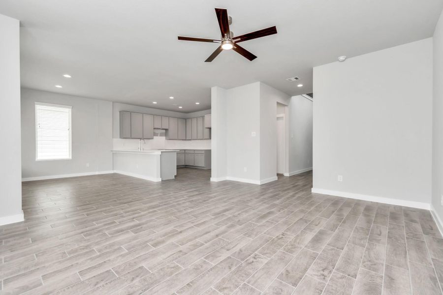 All of this overlooks your expansive family room, creating a perfect space for culinary delights and family gatherings. Sample photo of completed home with similar floor plan. Actual colors and selections may vary. All of this overlooks your expansive family room, creating a perfect space for culinary delights and family gatherings. Sample photo of completed home with similar floor plan. Actual colors and selections may vary.