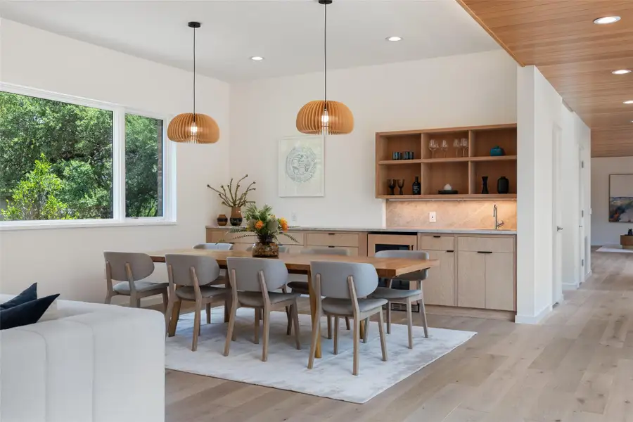 Dining area with recessed lighting, light wood-style floors, and wine cooler