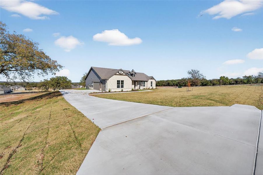 View of front of house with a front lawn, driveway, and a garage View of front of house with a front lawn, driveway, and a garage