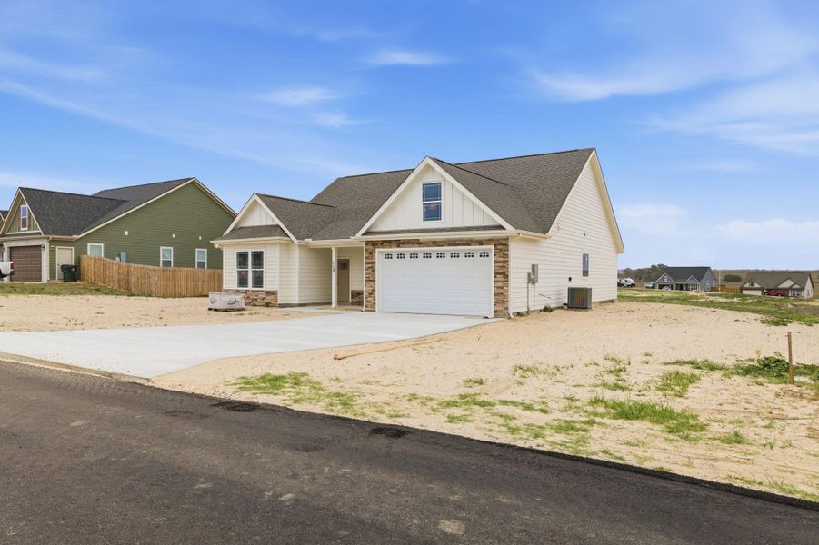 Front exterior of a new home in Las Palomas Country Club Estates, La Vernia, TX, highlighting curb appeal (Image 14).