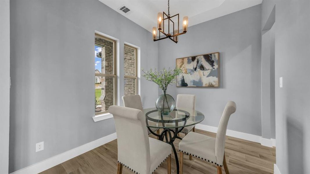 Dining area featuring a chandelier and wood finished floors