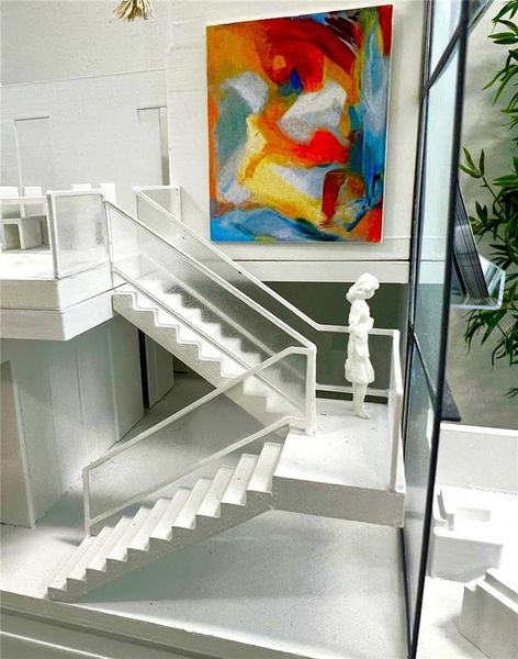 The model depicts the sweeping open staircase complimented by soaring 26-foot ceiling heights.