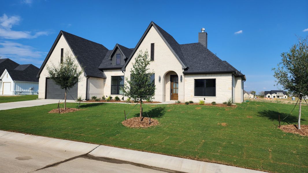Front exterior of a new home in Paloma Ranches, Justin, TX, highlighting curb appeal (Image 2). Front exterior of a new home in Paloma Ranches, Justin, TX, highlighting curb appeal (Image 2).