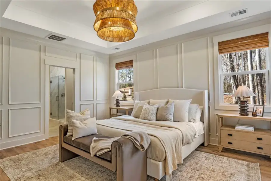 This primary bedroom features hardwood floors and
