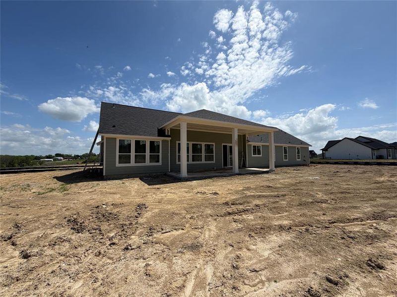 Rear view of property featuring a patio area